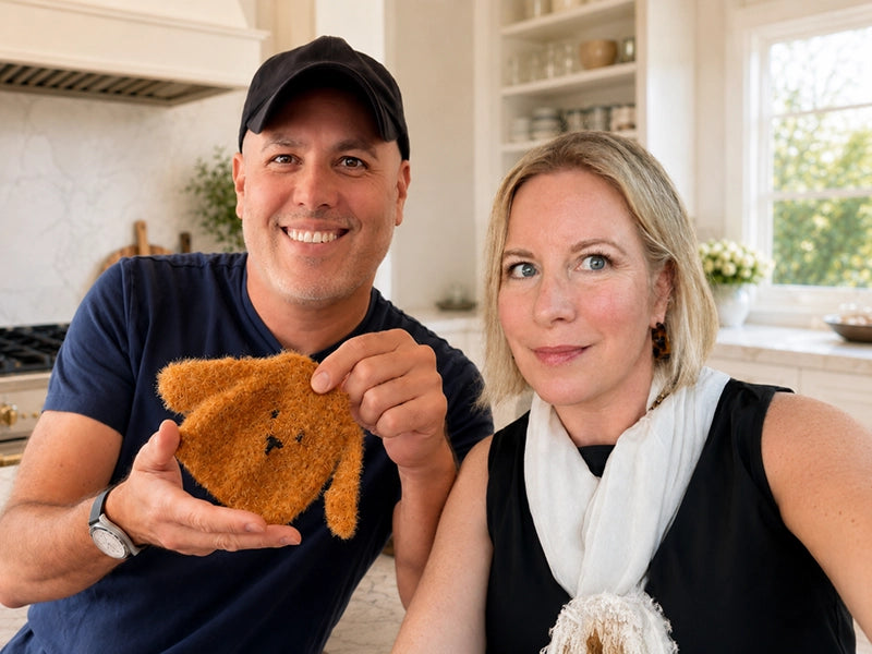 Joe and Rayna in a kitchen holding Rufus, a brown dog dish scrubby